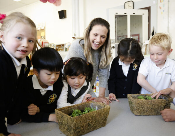 Students and teacher looking at plants